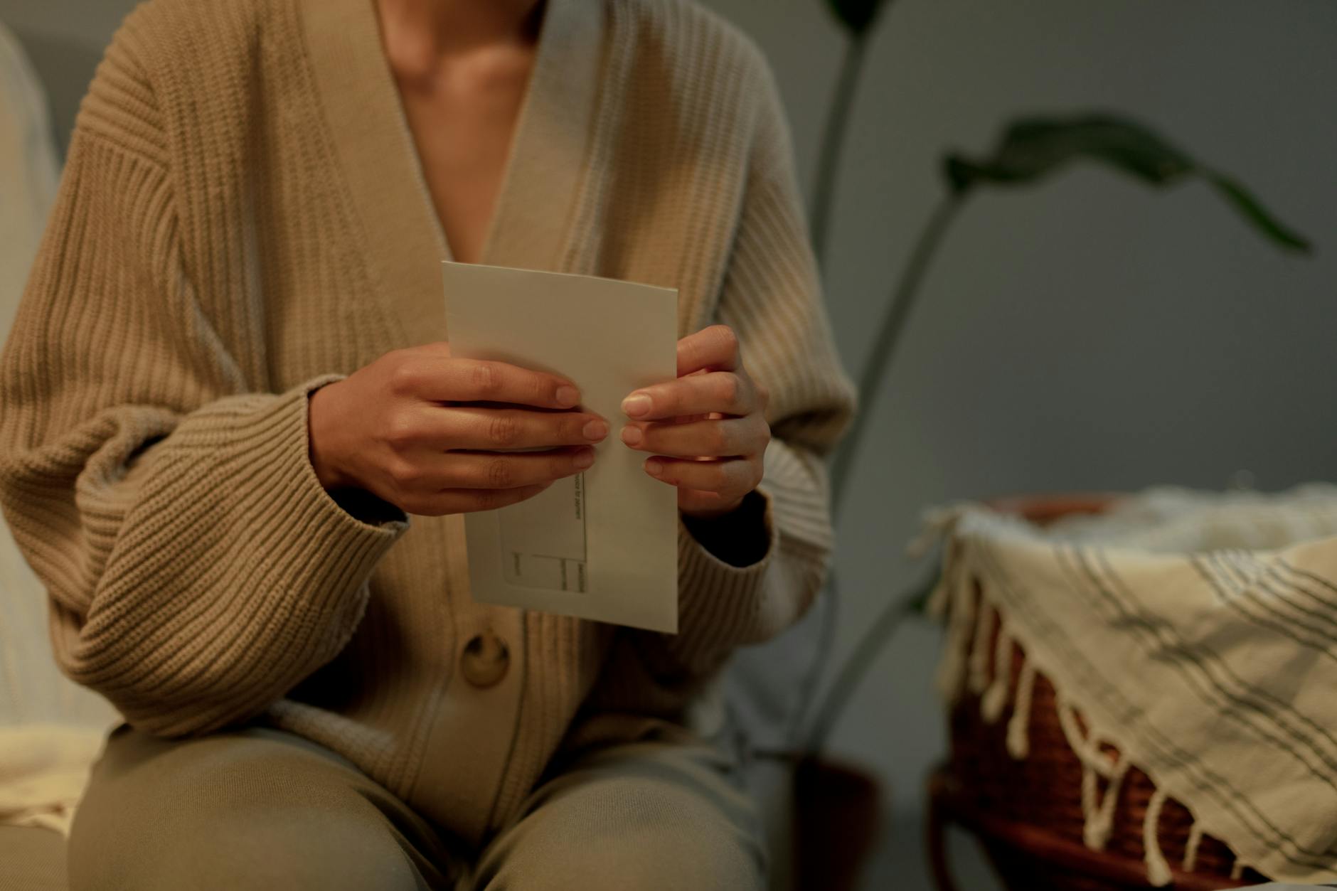 Female landlord reading an expired EPC certificate notice at home